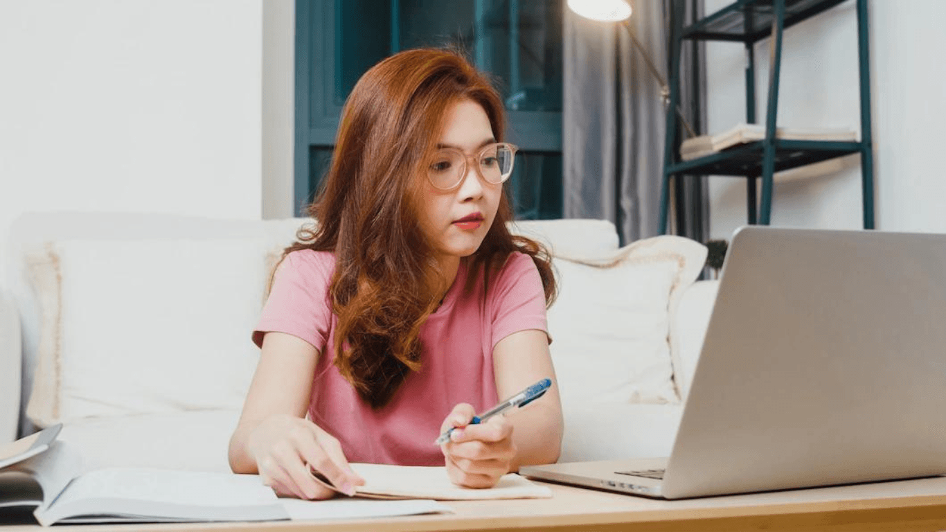 An ecommerce product description writer working at home in front of her laptop
