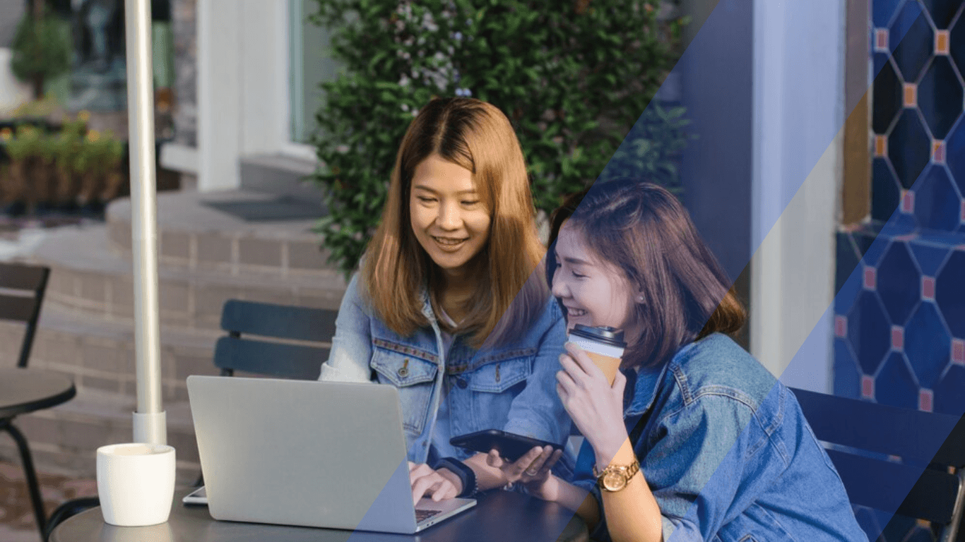 Two asian women checking emails 