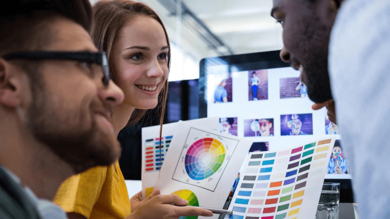 A team of graphic designers choosing a color from a color chart