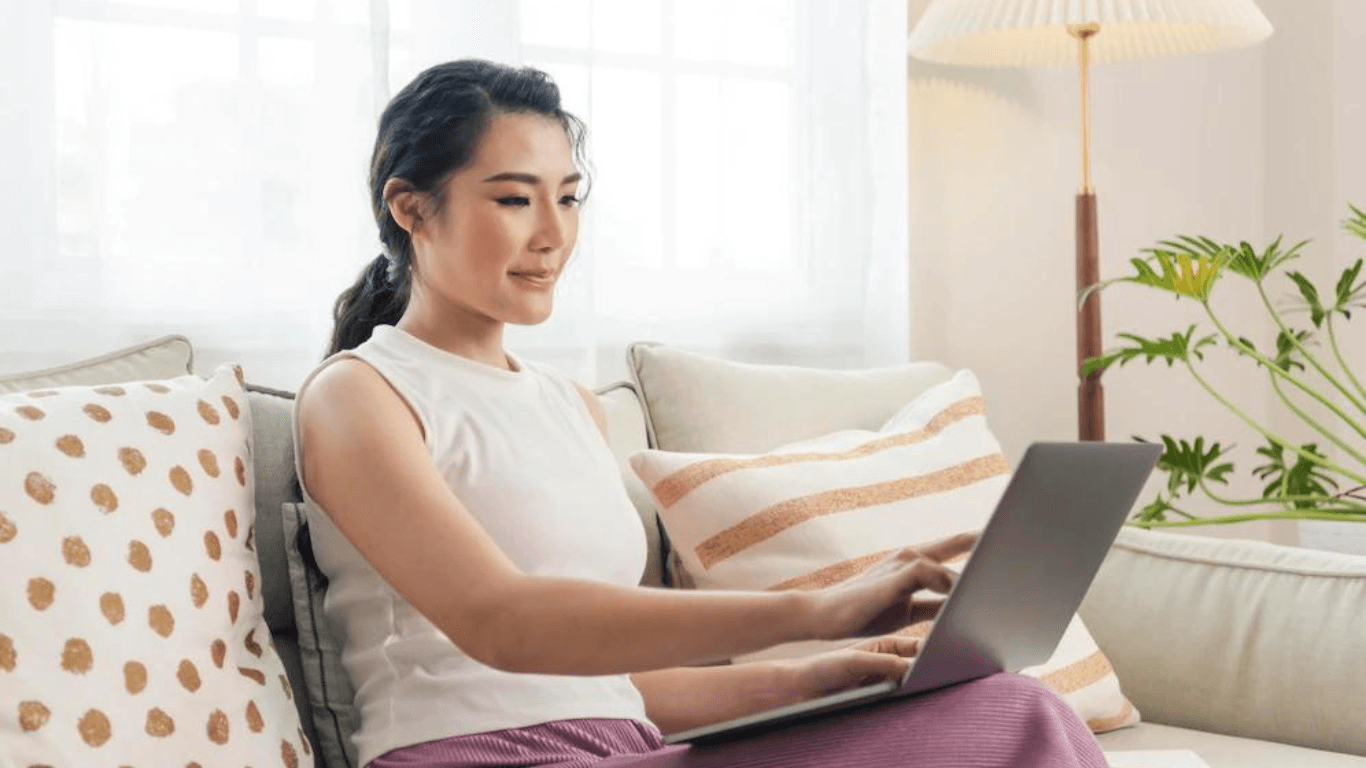 A female online retailer typing on her laptop at home